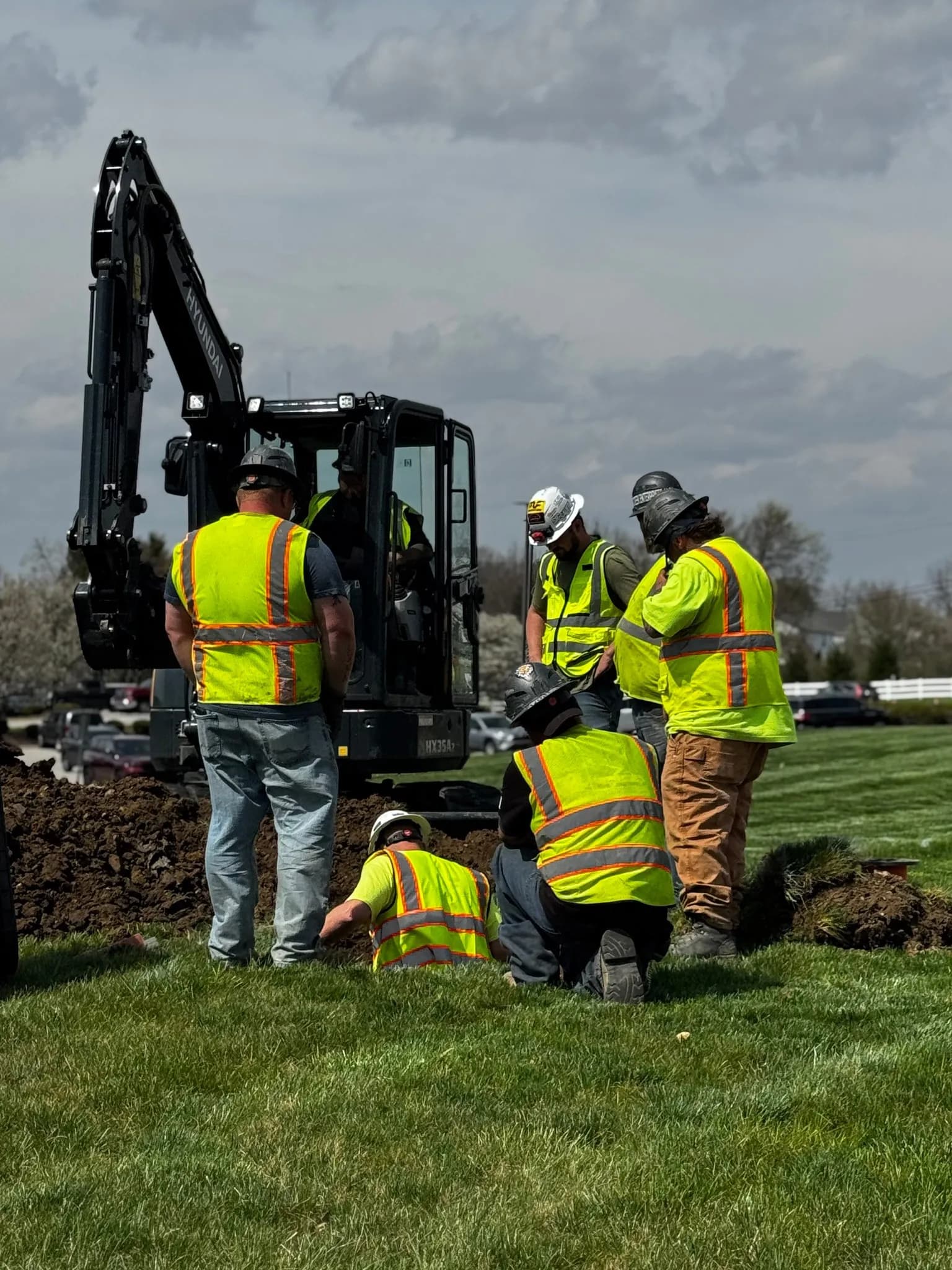 Excavation crew preparing underground conduit